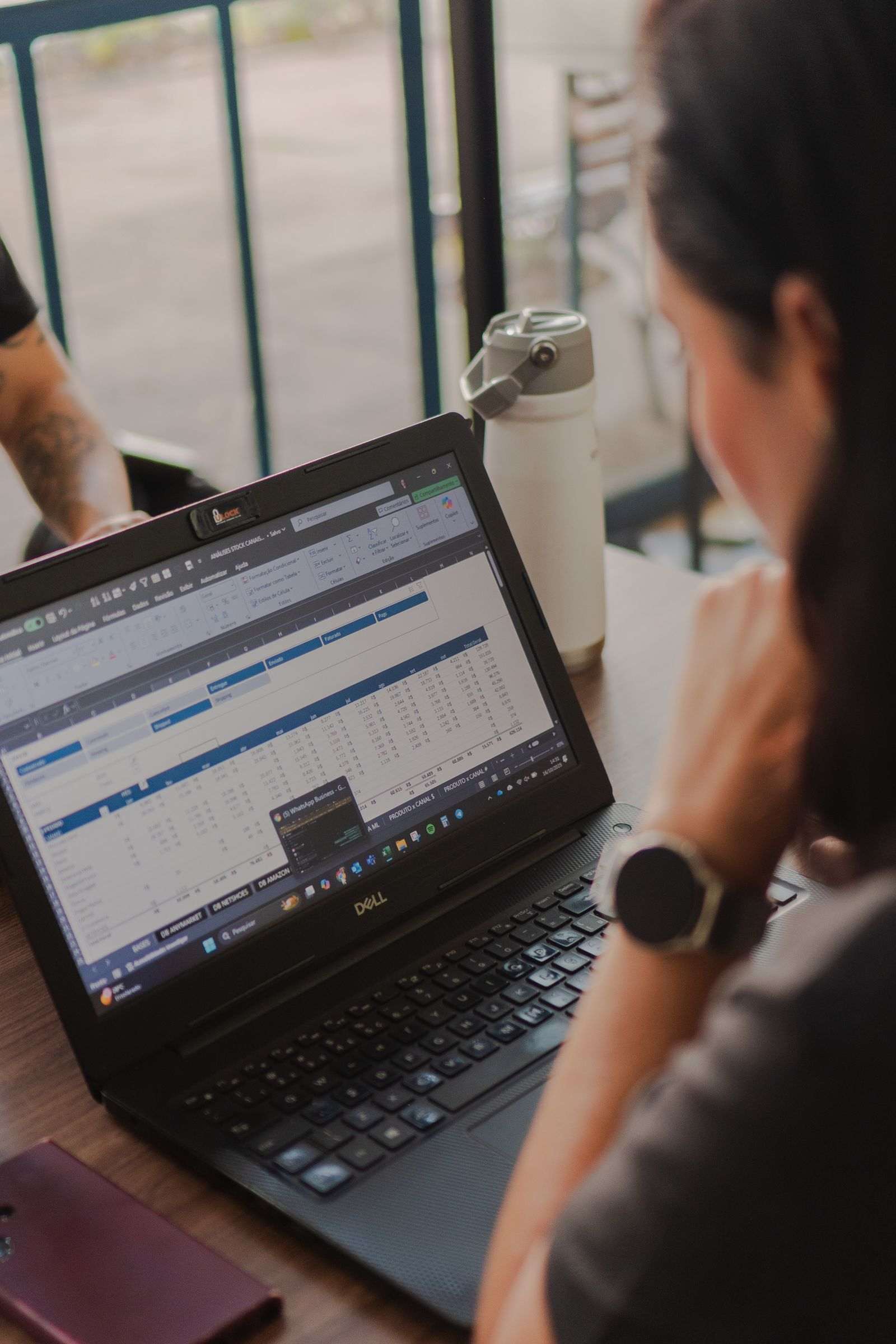 Person reviewing a spreadsheet of campaign figures on a laptop