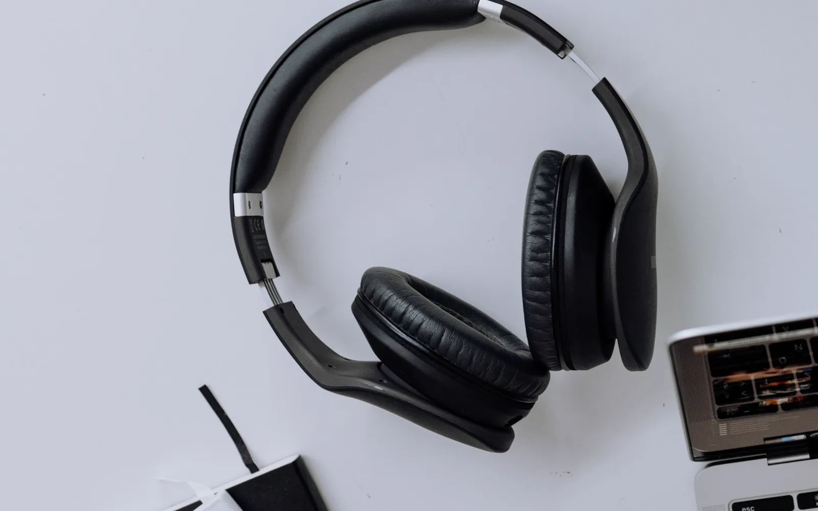 Headphones and a laptop on a desk