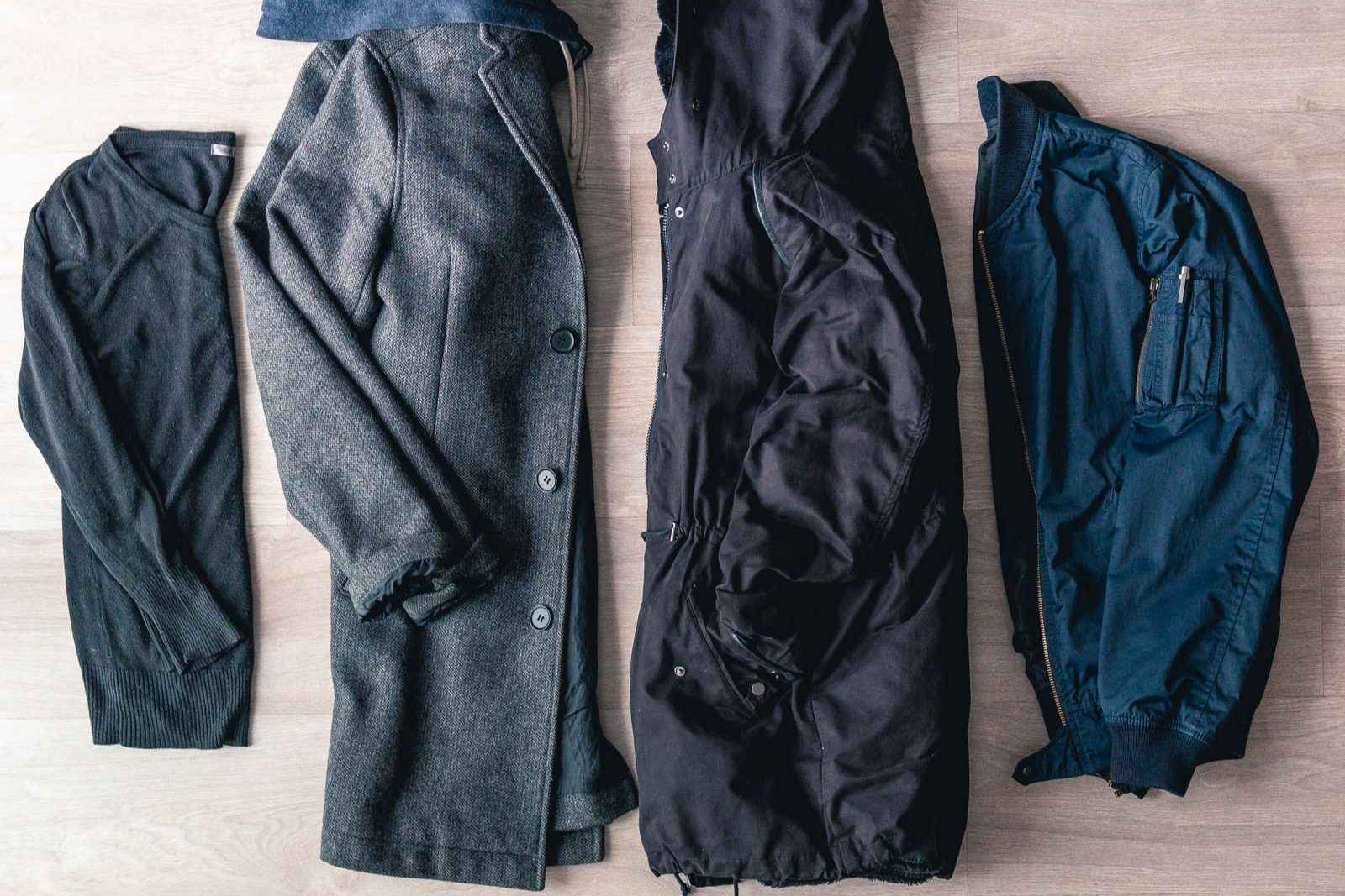 Flat lay of jackets on a wooden floor
