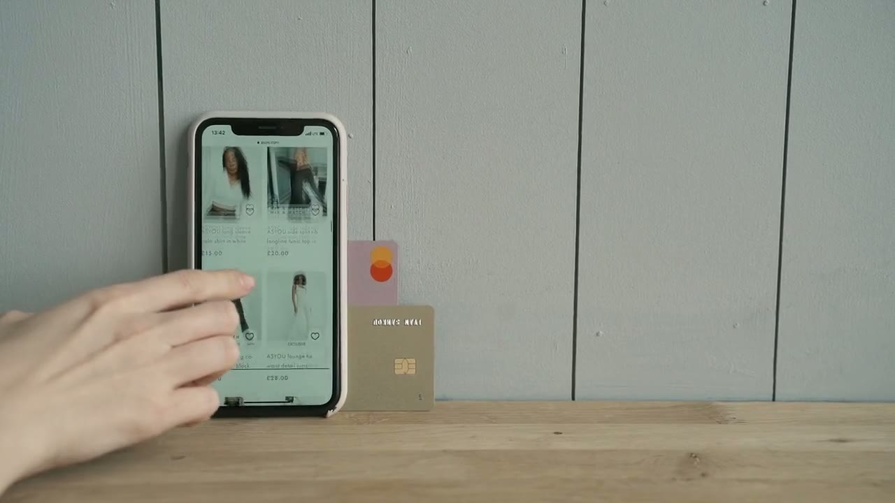 Hand using a smartphone to check out in an online store