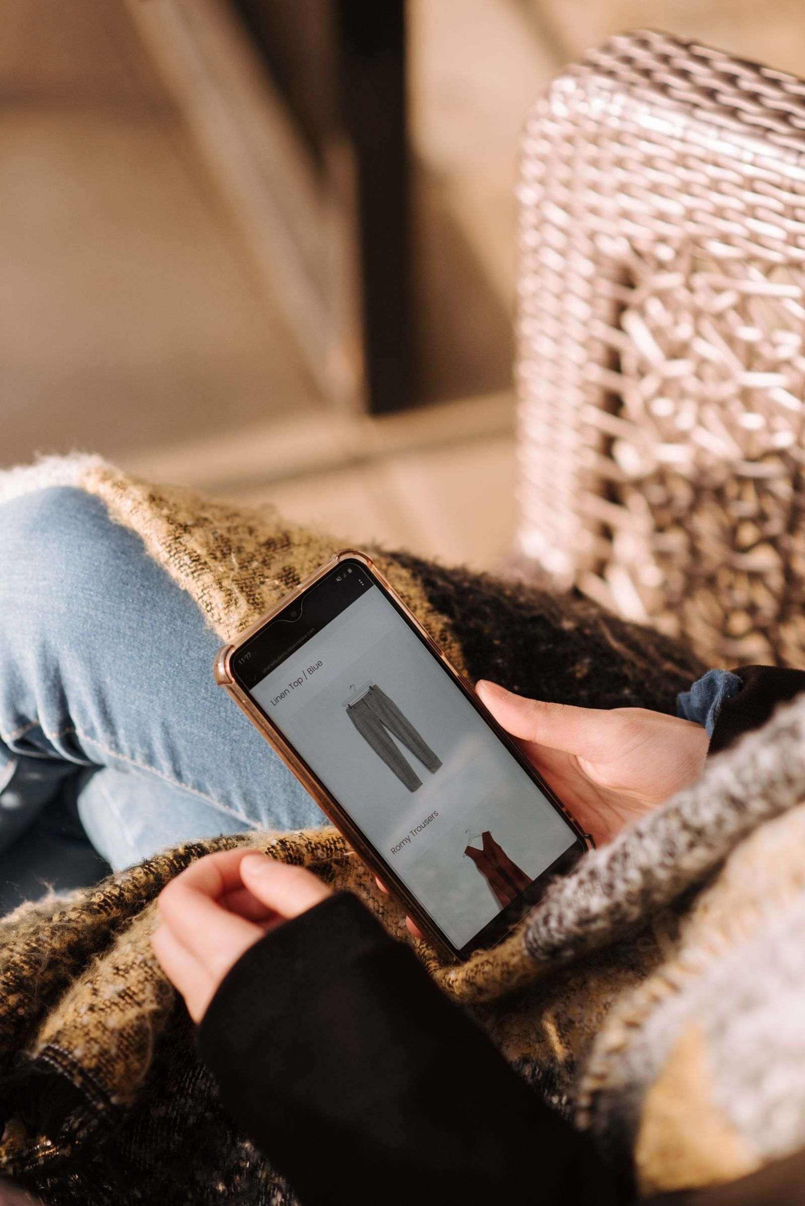 Shopper browsing clothing product listings on a smartphone