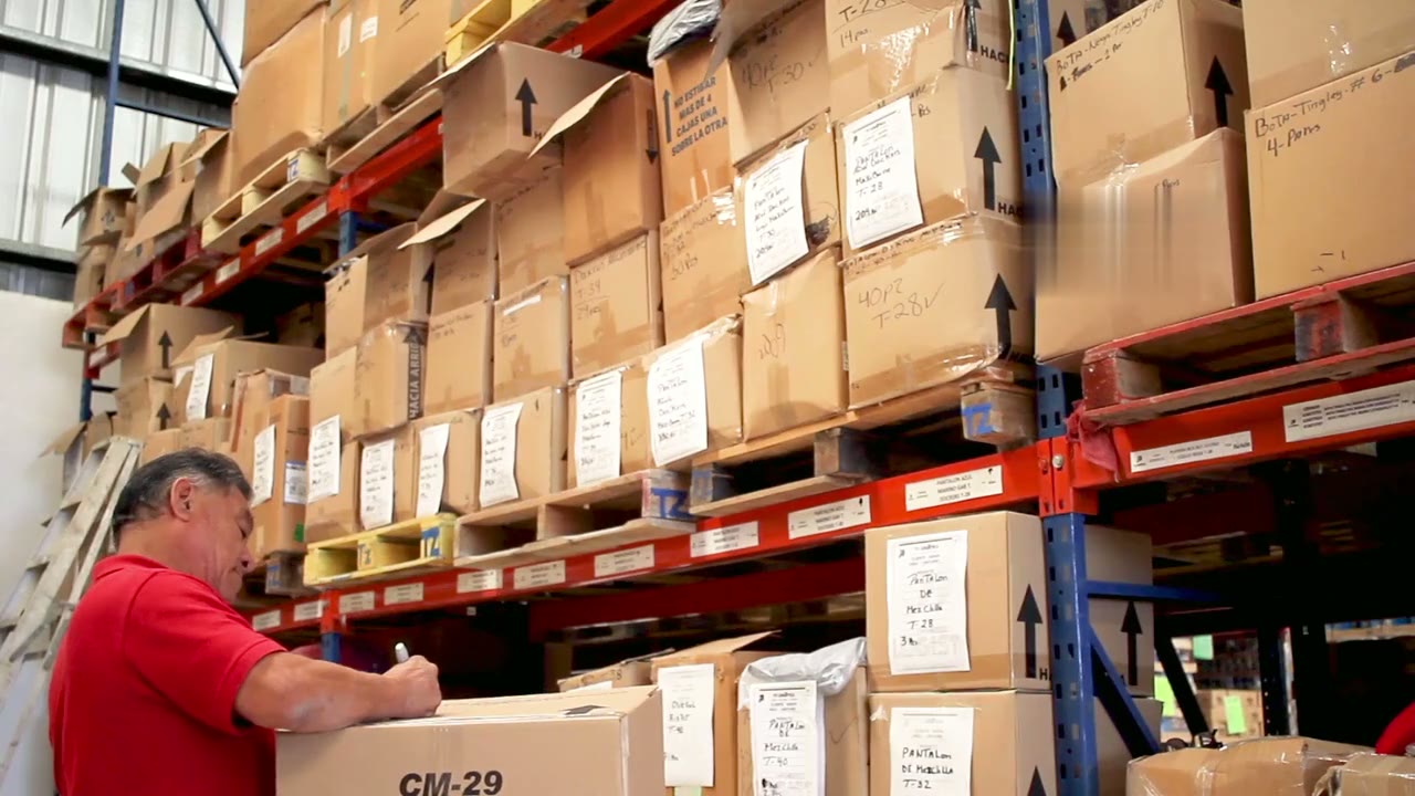 Warehouse worker labelling stock on shelving